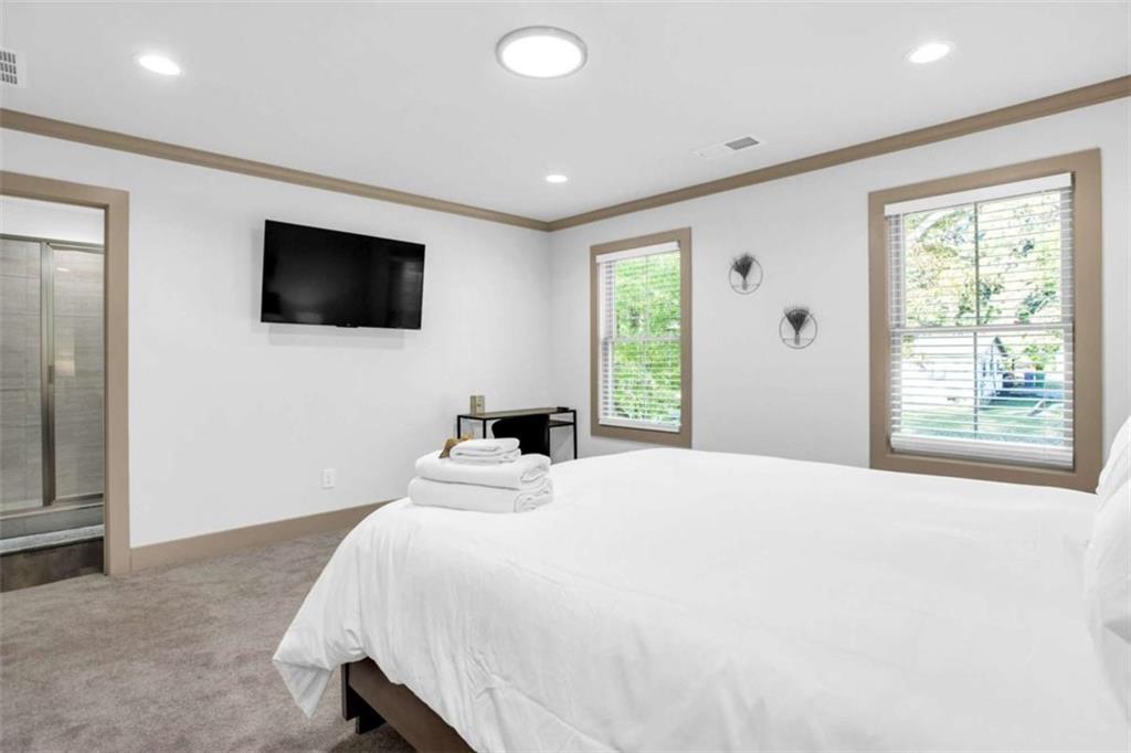 128 Nathan Road Southwest Atlanta, GA 30331 - Photo 30 of 36 a bedroom with a bed and a flat screen tv