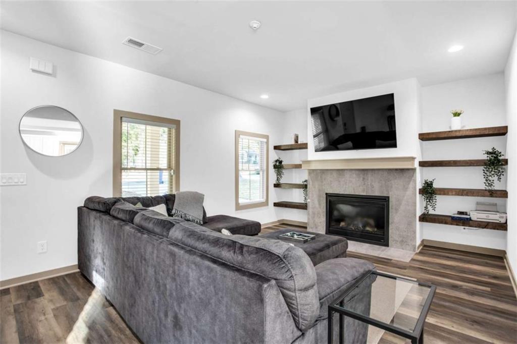 128 Nathan Road Southwest Atlanta, GA 30331 - Photo 4 of 36 a living room with furniture a flat screen tv and a fireplace