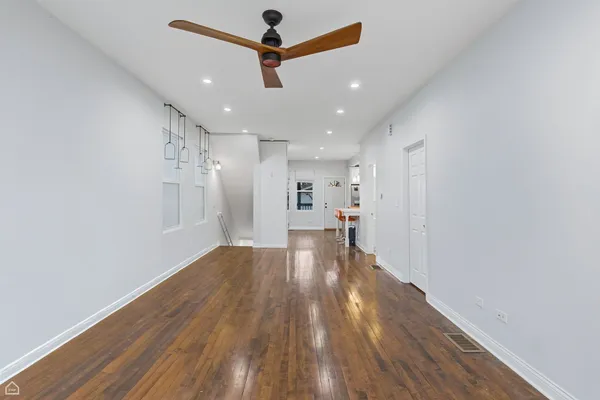 a view of a kitchen with a dishwasher and wooden floor