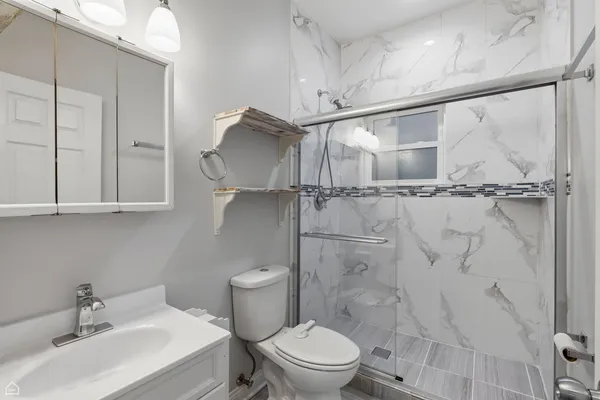 a white toilet sitting next to a bathroom sink