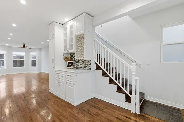 a very nice looking room with wooden floor and staircase