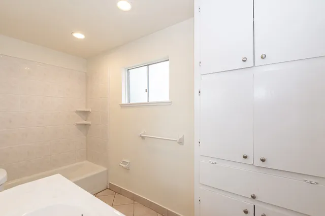 a bathroom with a bathtub and shower
