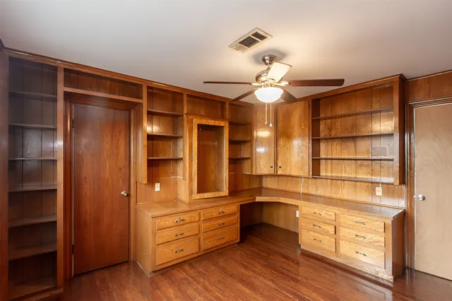 a view of a walk in closet and wooden shelves