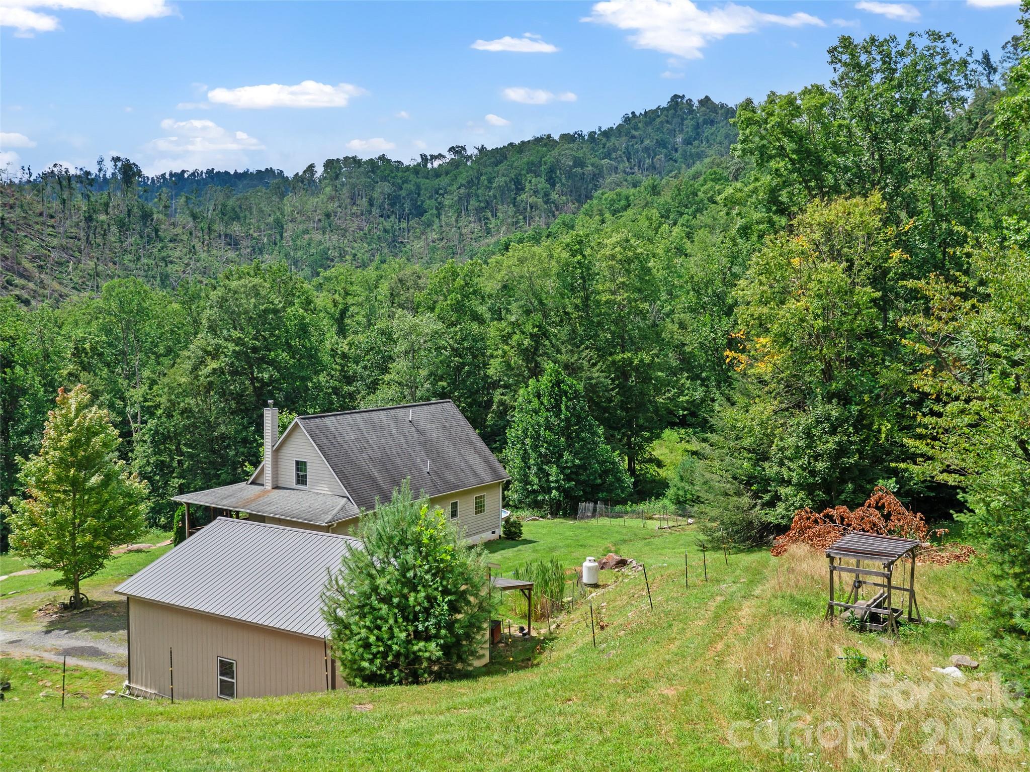 2216 Beans Creek Road Bakersville, NC 28705 - Photo 37 of 39 a view of a house with a yard and sitting area