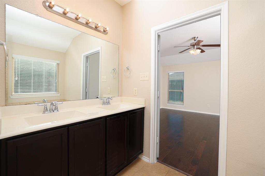 1109 Kaufman Road Melissa, TX 75454 - Photo 11 of 22 a bathroom with a double vanity sink and a mirror