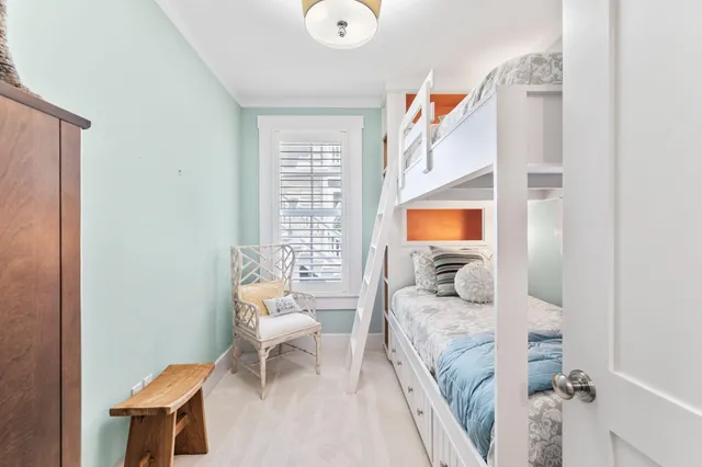 a living room with furniture a flat screen tv and a floor to ceiling window