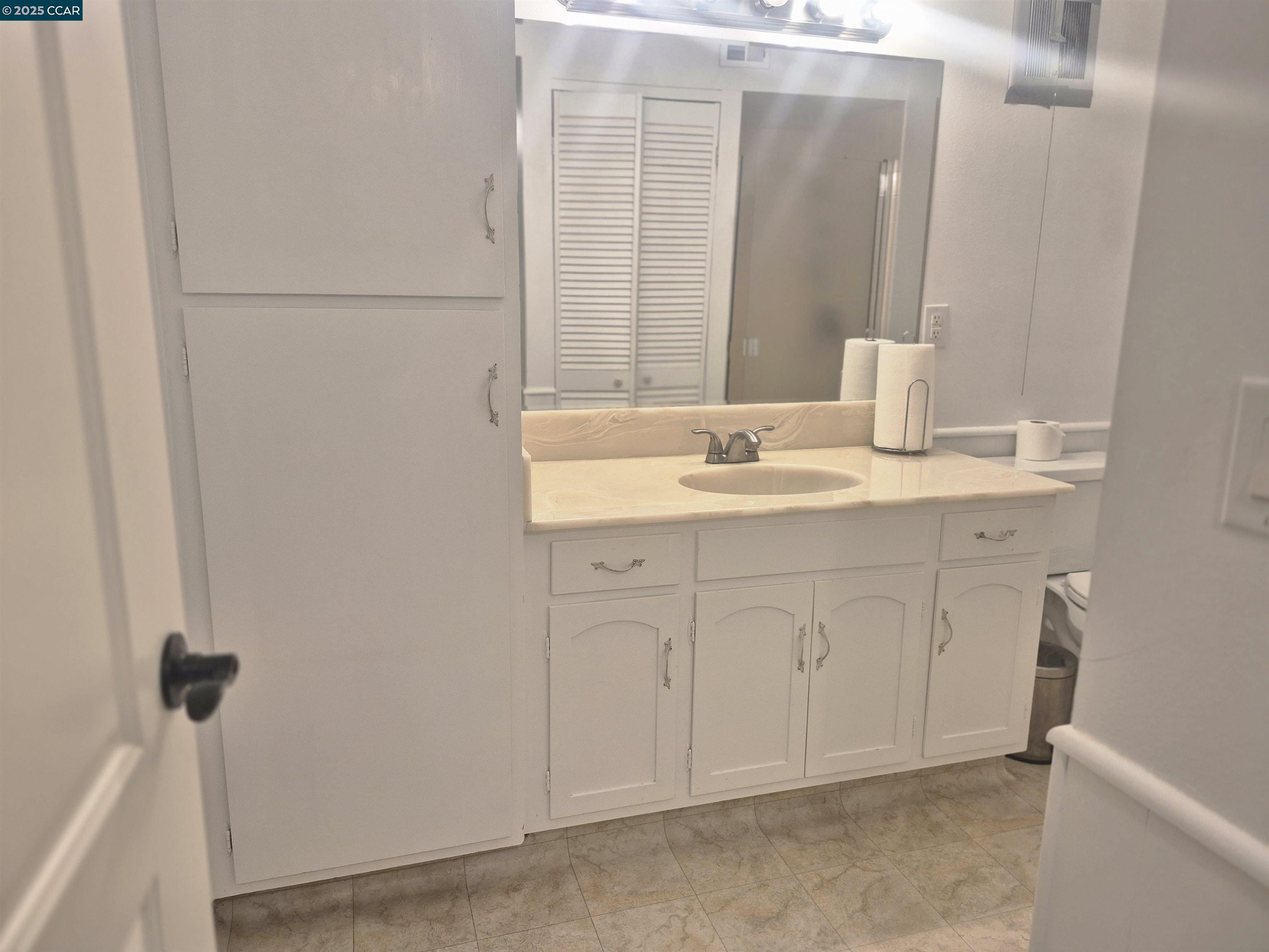 1832 Golden Rain Road, Unit 6 Walnut Creek, CA 94595 - Photo 11 of 36 a bathroom with a sink and a mirror