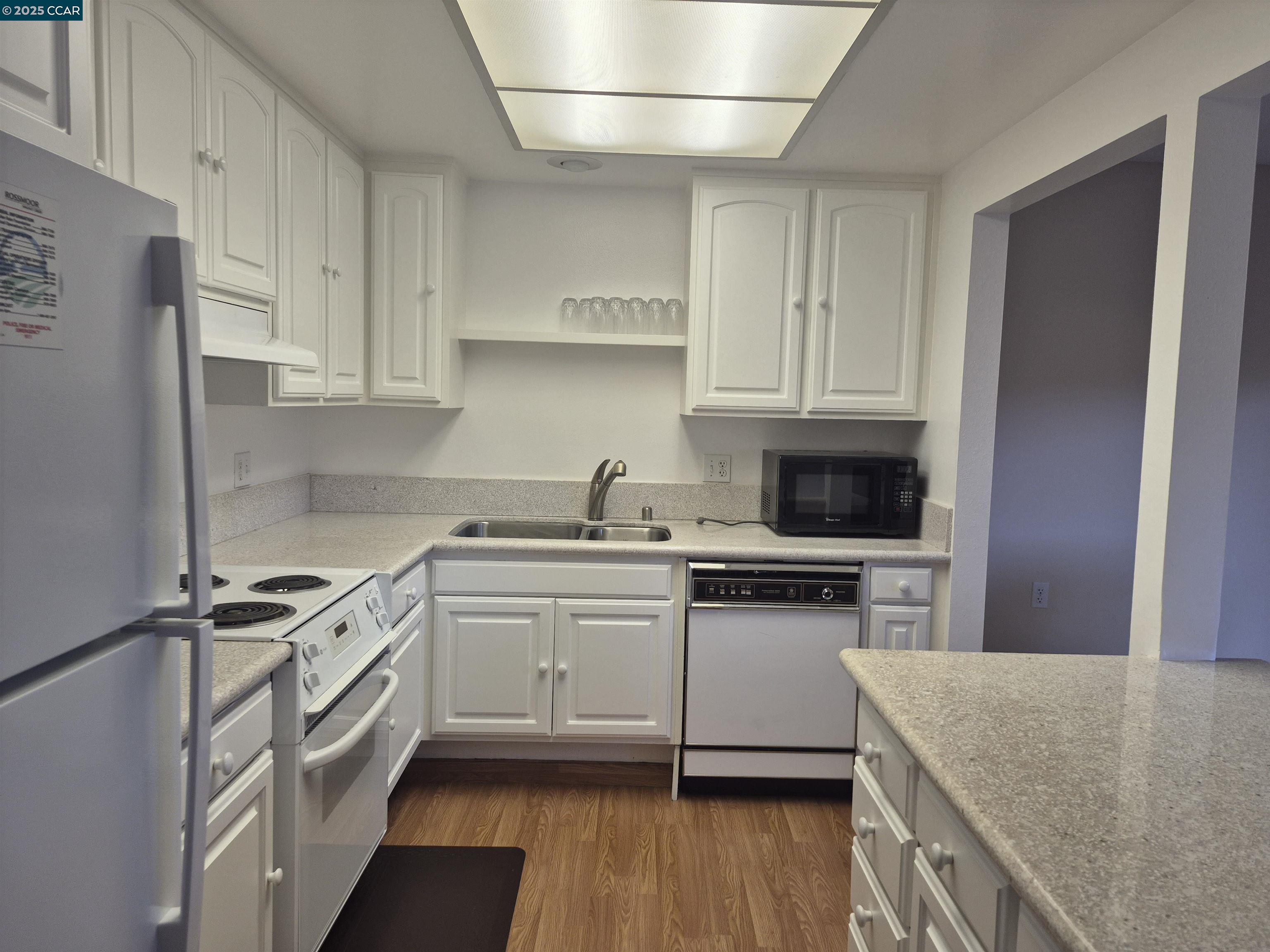 1832 Golden Rain Road, Unit 6 Walnut Creek, CA 94595 - Photo 13 of 36 a kitchen with stainless steel appliances granite countertop a sink stove and refrigerator
