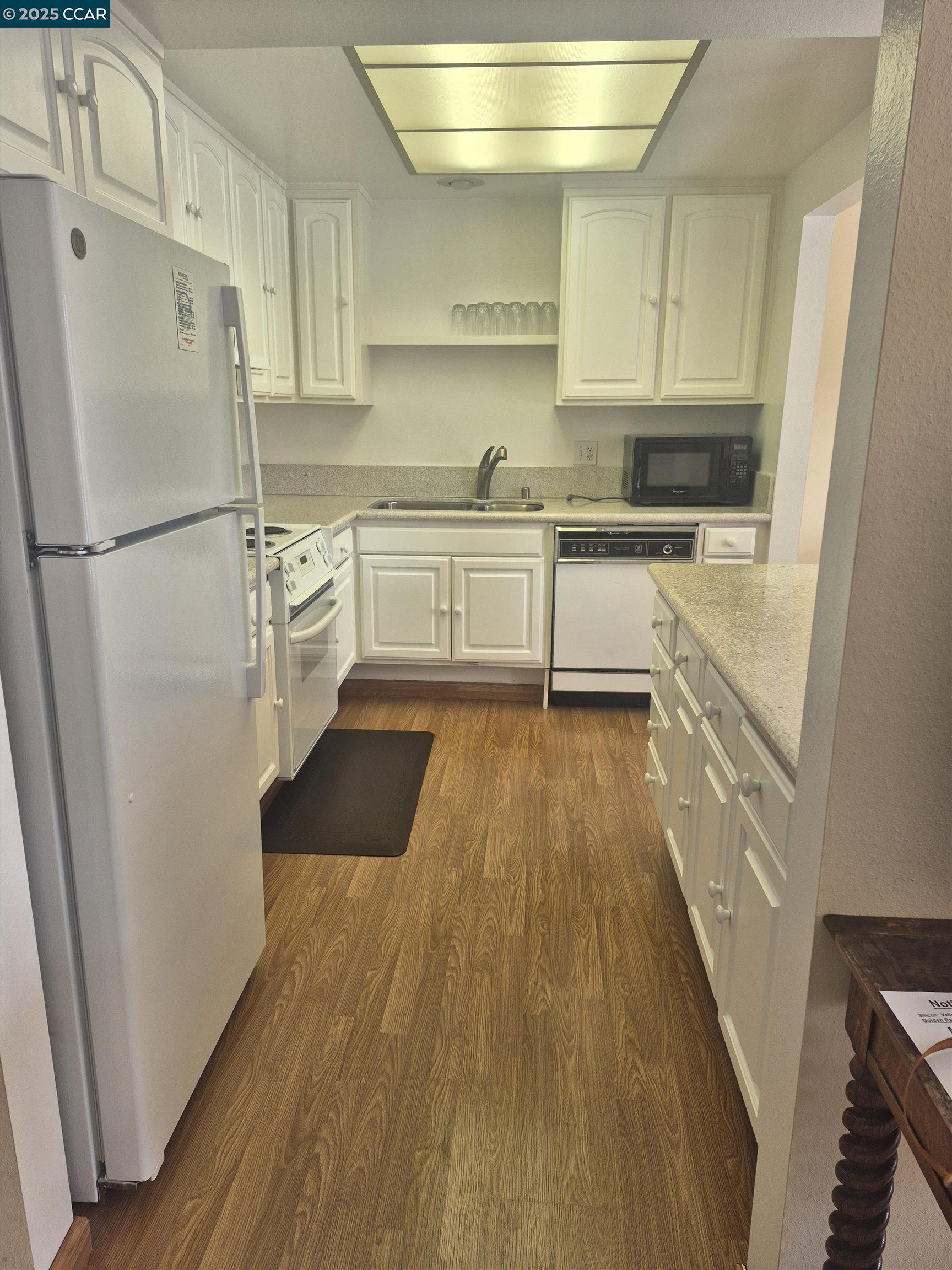1832 Golden Rain Road, Unit 6 Walnut Creek, CA 94595 - Photo 14 of 36 a kitchen with a refrigerator a sink and dishwasher
