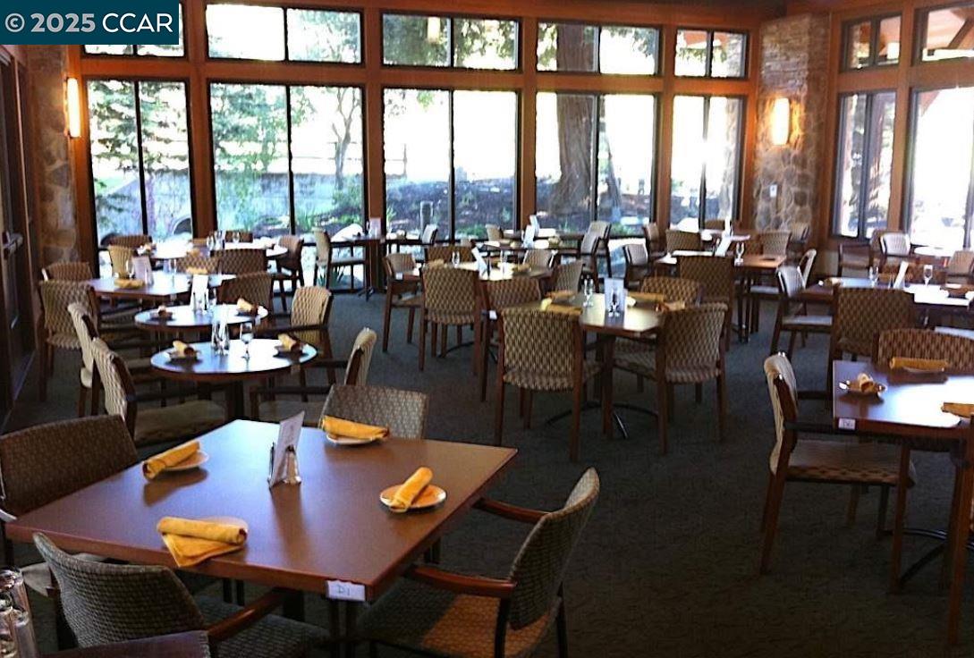 1832 Golden Rain Road, Unit 6 Walnut Creek, CA 94595 - Photo 17 of 36 a view of a dining room with furniture and a floor to ceiling window