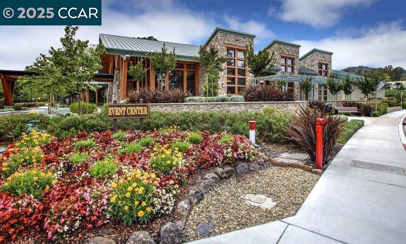 1832 Golden Rain Road, Unit 6 Walnut Creek, CA 94595 - Photo 23 of 36 a front view of a house with a yard garden and fountain