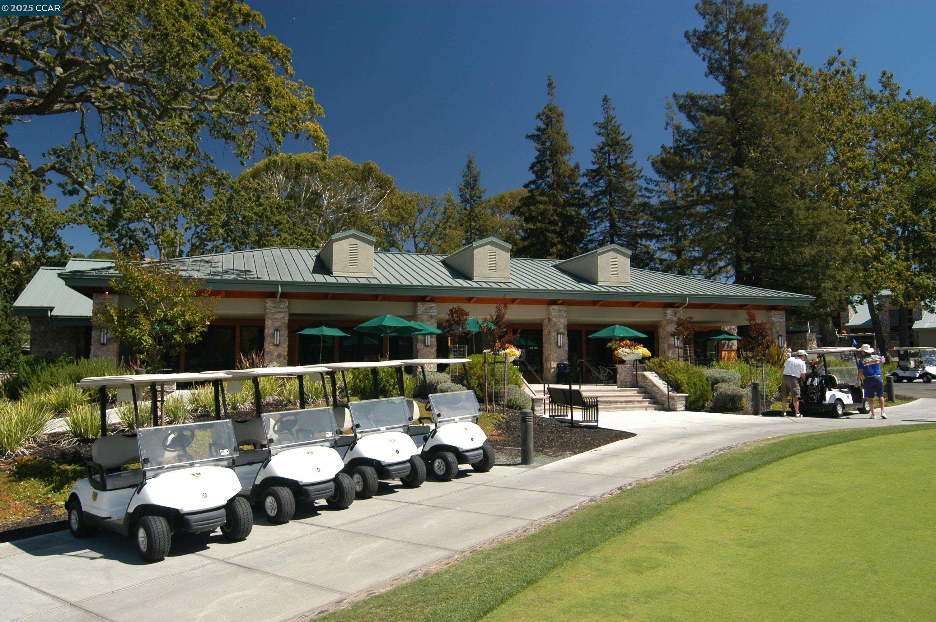 1832 Golden Rain Road, Unit 6 Walnut Creek, CA 94595 - Photo 25 of 36 a view of a patio with couches table and chairs under an umbrella with a garden