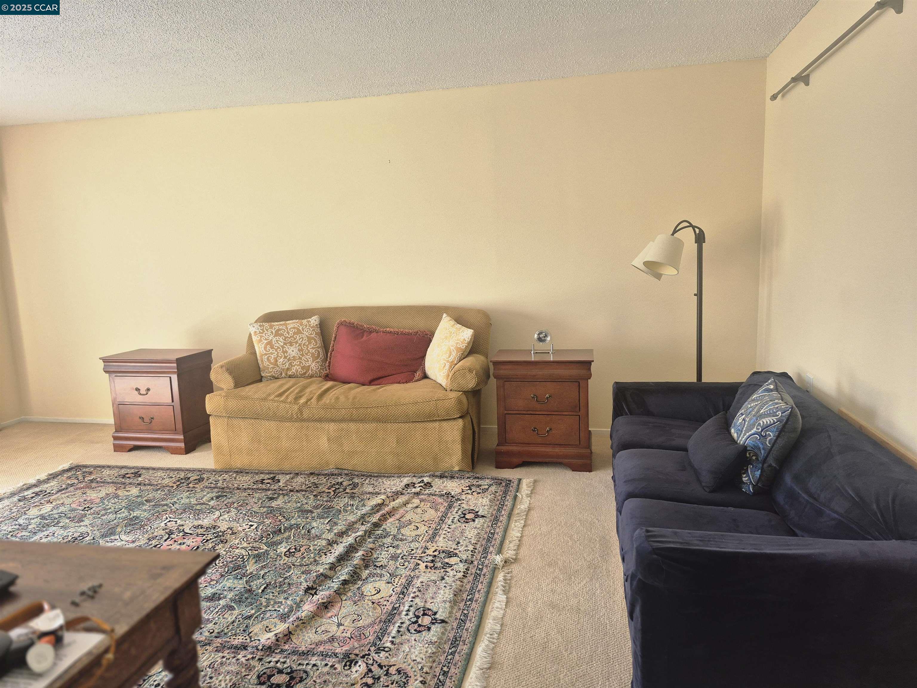 1832 Golden Rain Road, Unit 6 Walnut Creek, CA 94595 - Photo 3 of 36 a bedroom with a bed and a couch