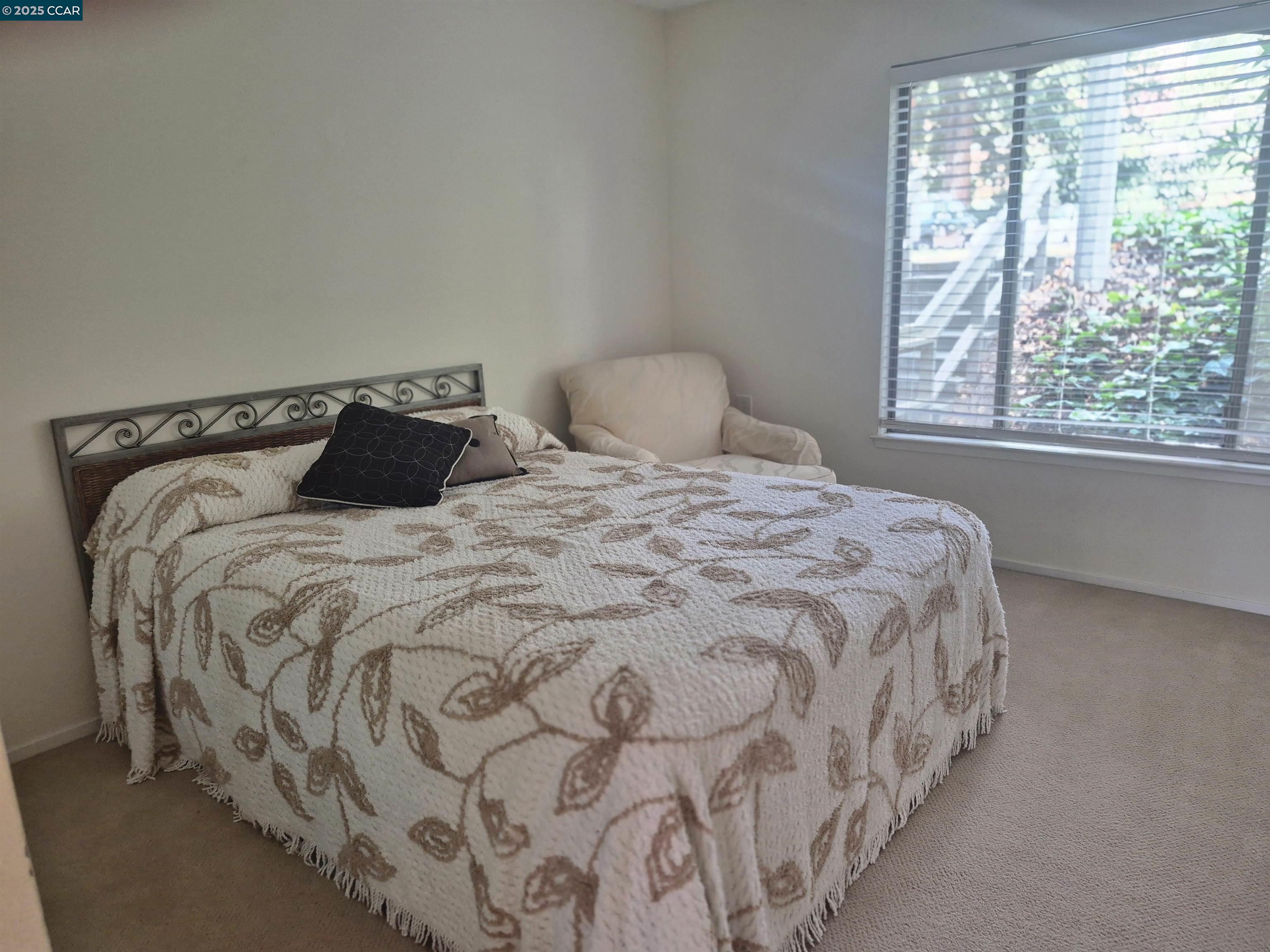 1832 Golden Rain Road, Unit 6 Walnut Creek, CA 94595 - Photo 10 of 36 a large bed sitting in a bedroom next to a window