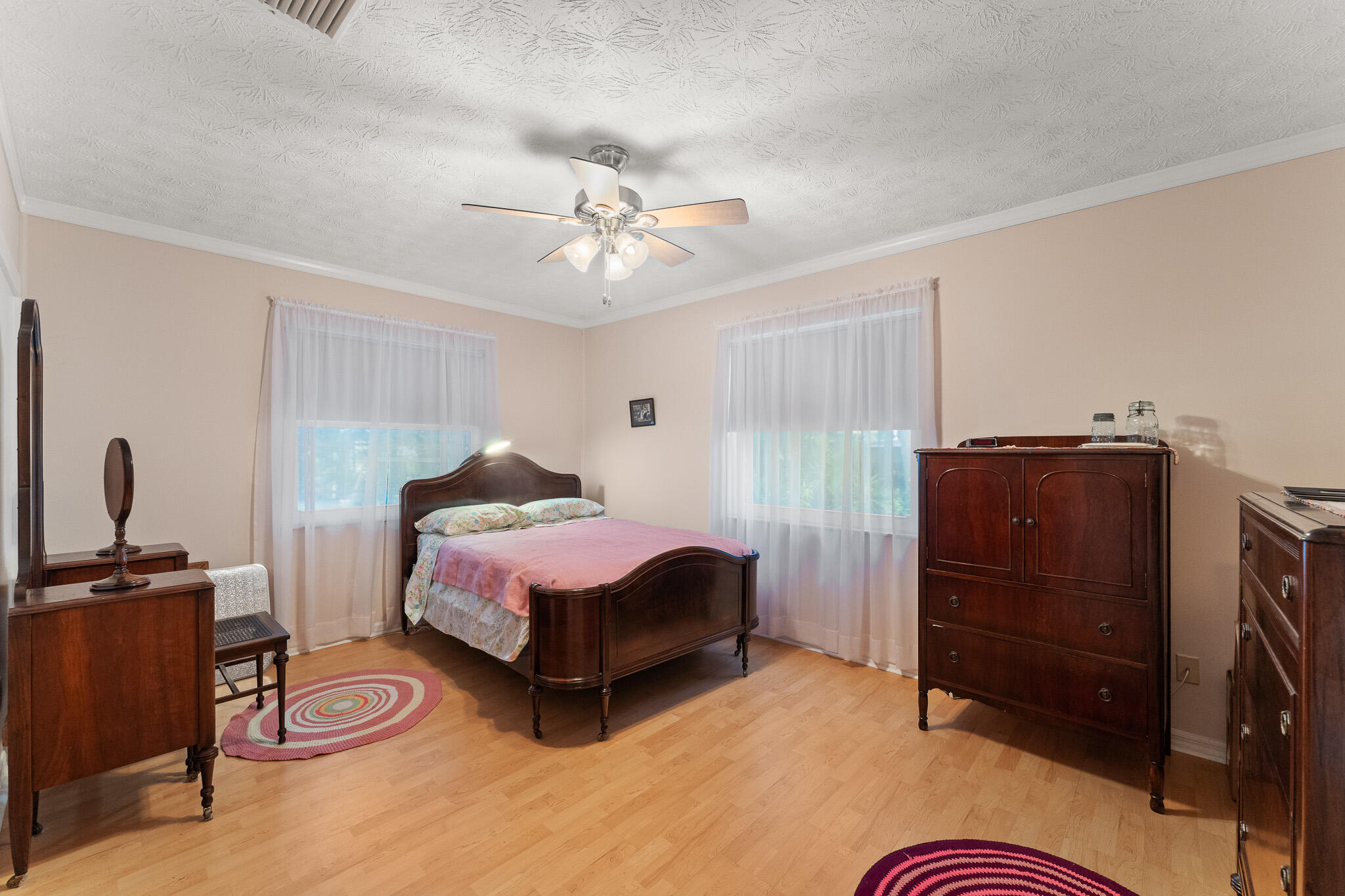 1653 Southwest 85th Terrace Stuart, FL 34997 - Photo 35 of 54 a spacious bedroom with a bed dresser and a walk in closet