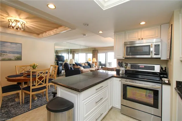 a kitchen with a stove a sink and a microwave