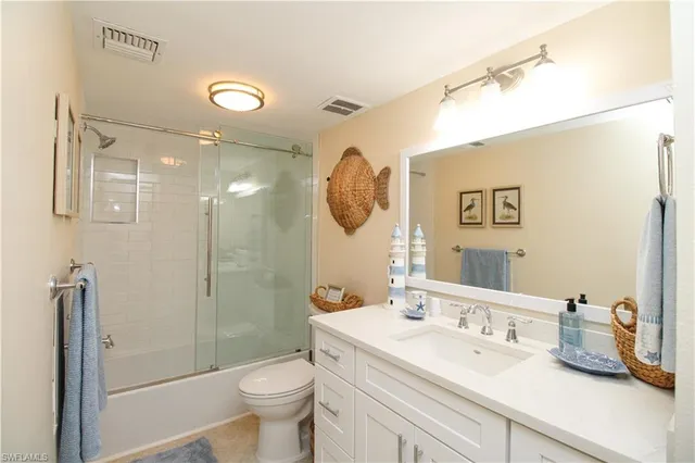 a bathroom with a toilet sink and shower