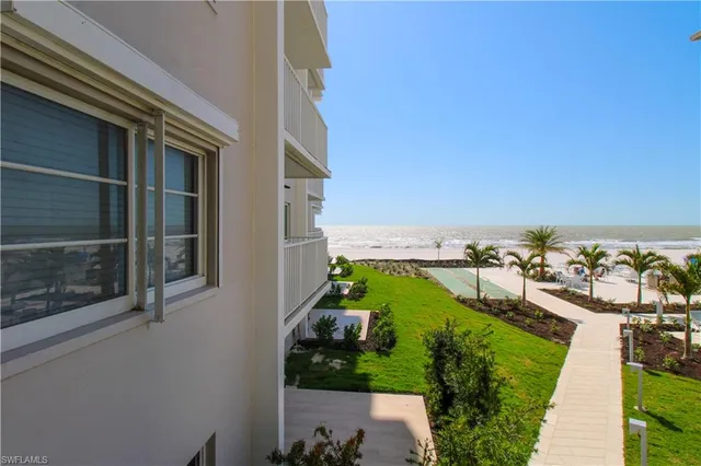 an aerial view of a house with a garden and mountain view