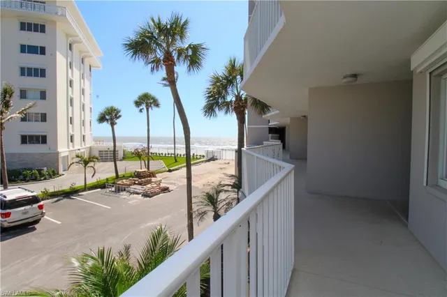 a view of a balcony with palm trees
