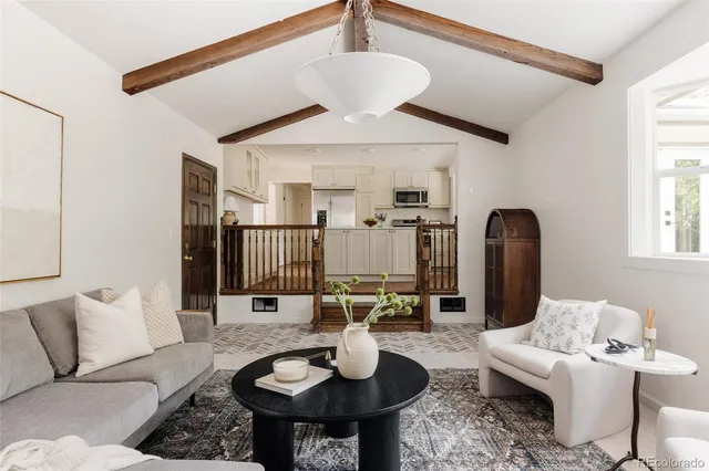a living room with furniture and a chandelier