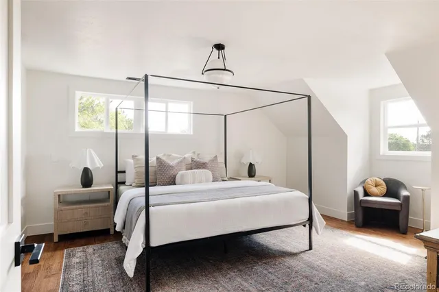 a bedroom with a bed a couch and window