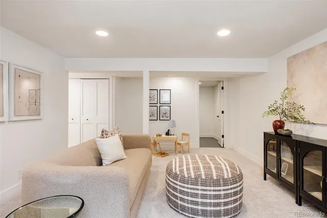 a living room with furniture a couch and a potted plant