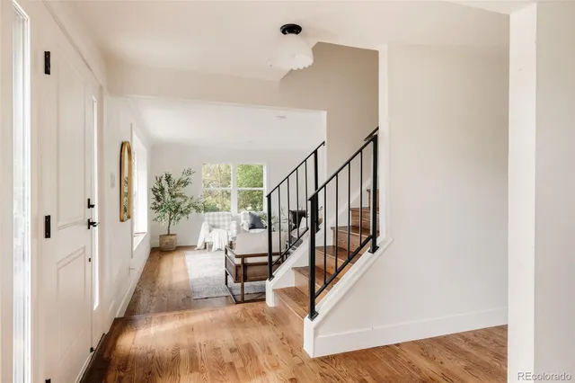 a view of entryway and hall with wooden floor