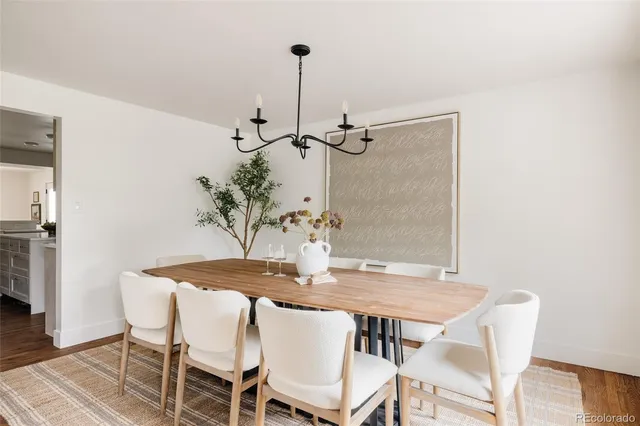 a dining room with furniture and wooden floor