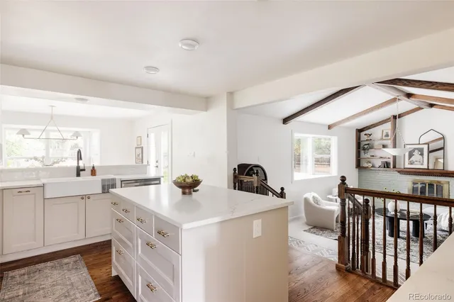 a view of a kitchen with a sink stainless steel appliances cabinets and a large window