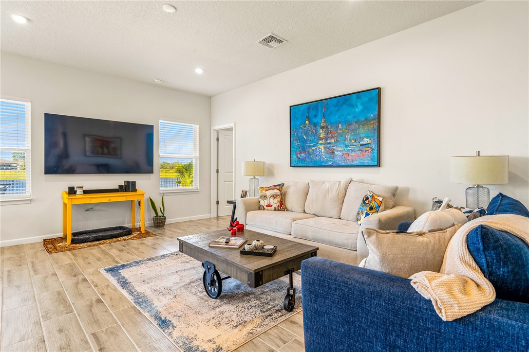 4202 Keeson Circle Vero Beach, FL 32967 - Photo 12 of 36 a living room with furniture and a flat screen tv