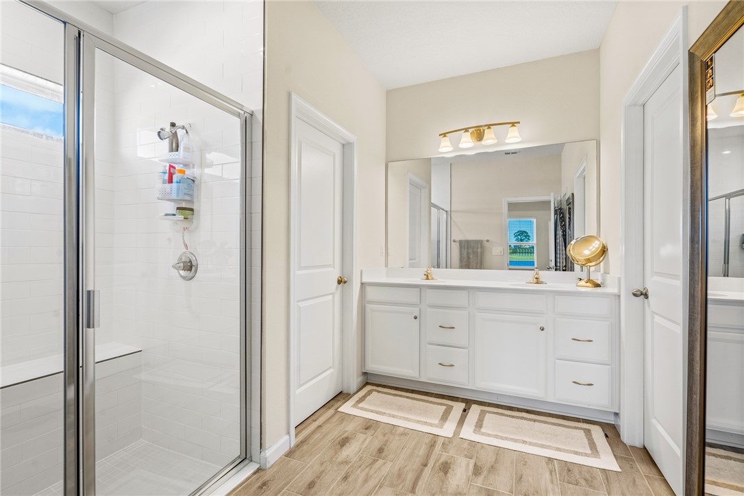 4202 Keeson Circle Vero Beach, FL 32967 - Photo 24 of 36 a spacious bathroom with a shower and a sink