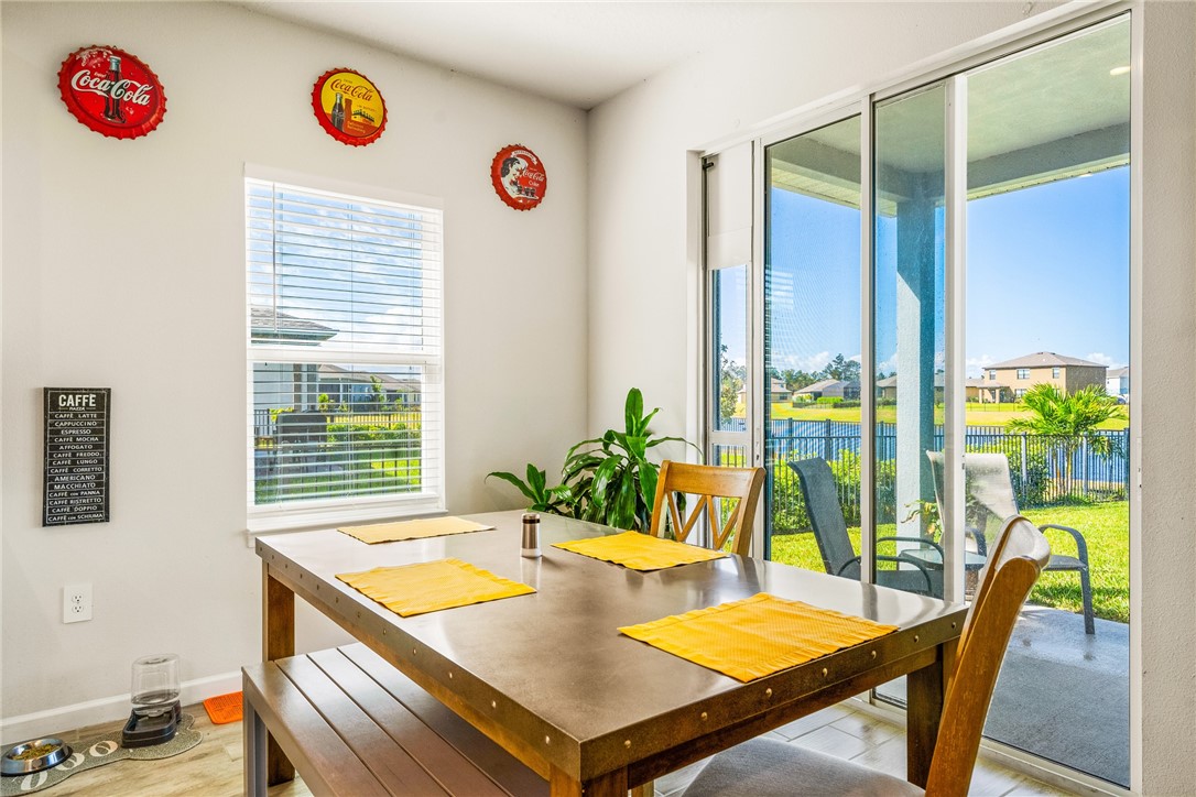 4202 Keeson Circle Vero Beach, FL 32967 - Photo 8 of 36 a view of a dining room with furniture and a potted plant