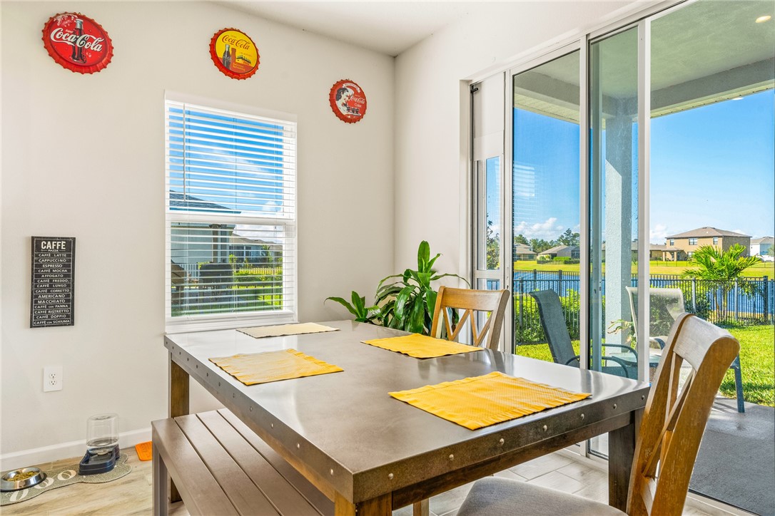 4202 Keeson Circle Vero Beach, FL 32967 - Photo 10 of 36 a view of a dining room with furniture and a potted plant