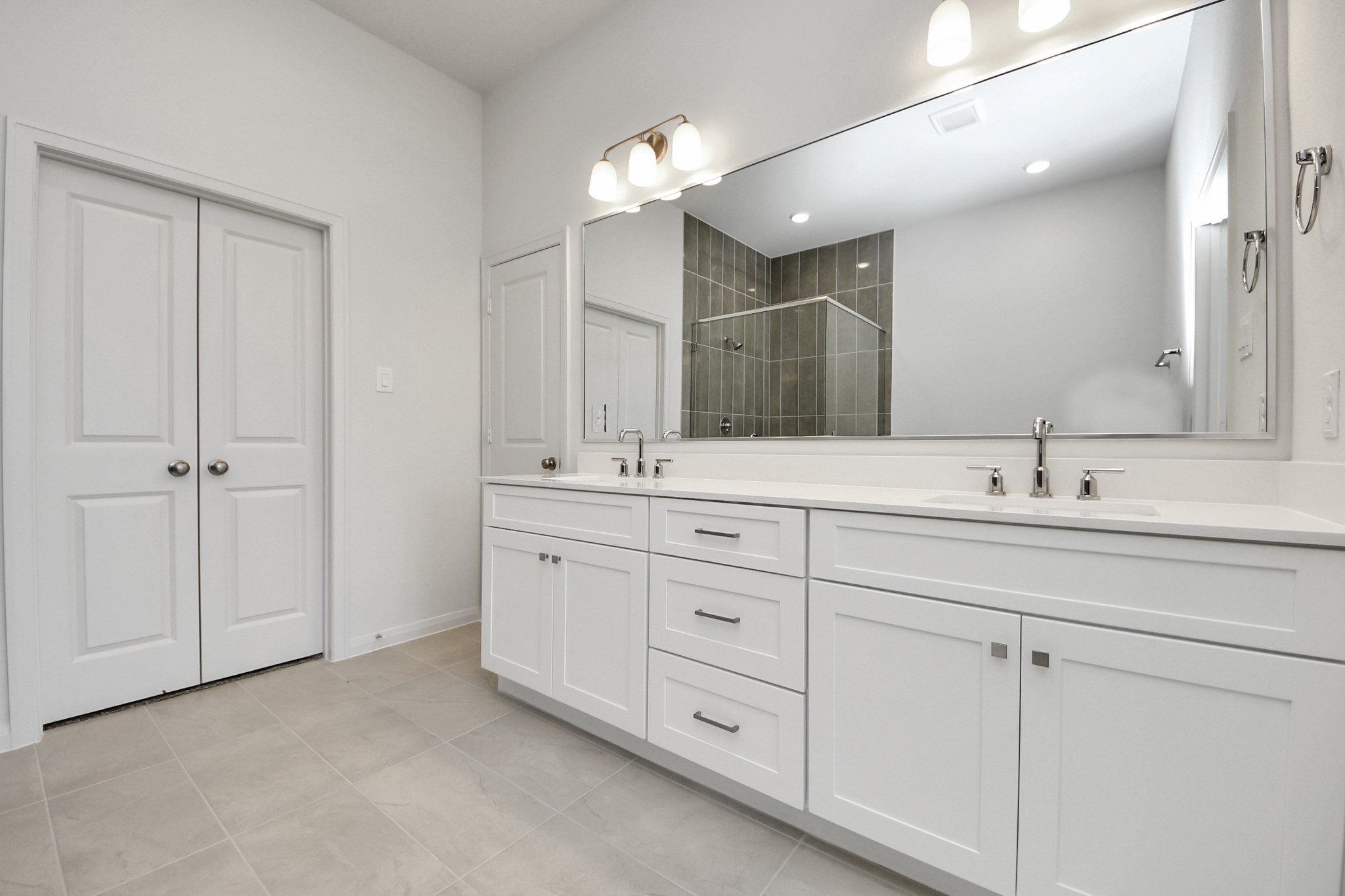 363 Legacy Point, Unit A Sealy, TX 77474 - Photo 11 of 26 a bathroom with double sink and a mirror