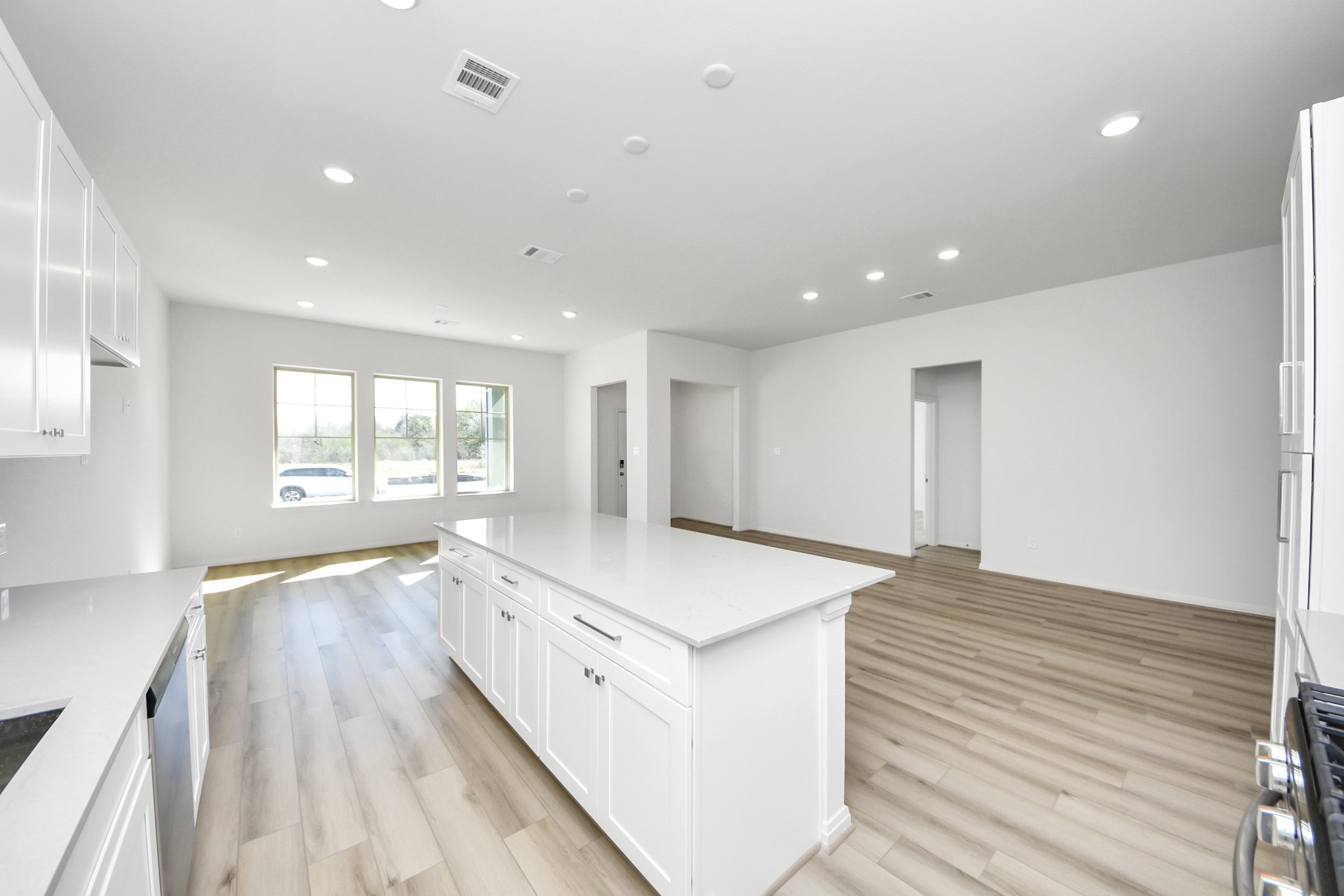 363 Legacy Point, Unit A Sealy, TX 77474 - Photo 19 of 26 a large white kitchen with wooden floors and wide window