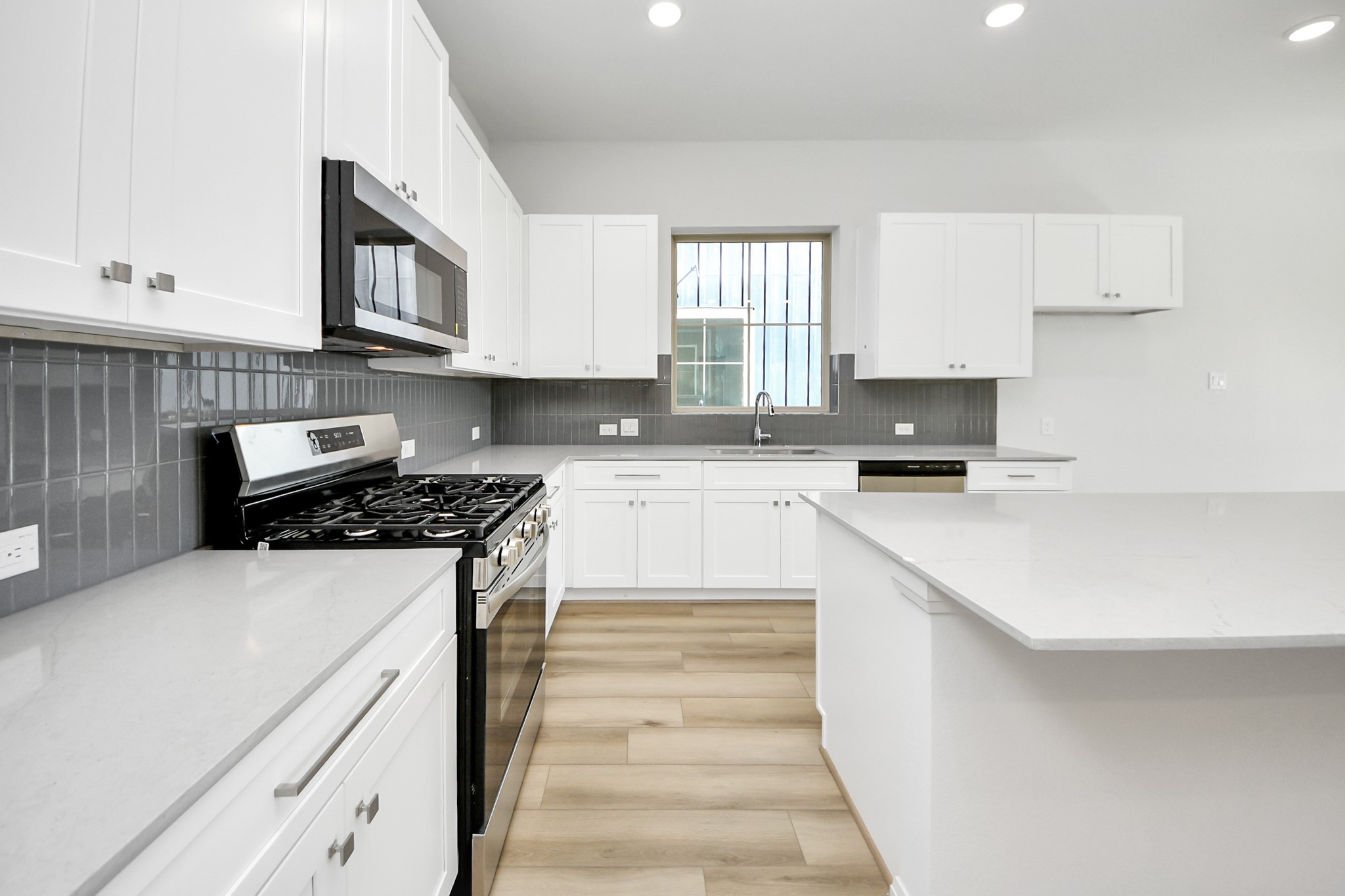 363 Legacy Point, Unit A Sealy, TX 77474 - Photo 20 of 26 a kitchen with kitchen island granite countertop a sink and a stove top oven