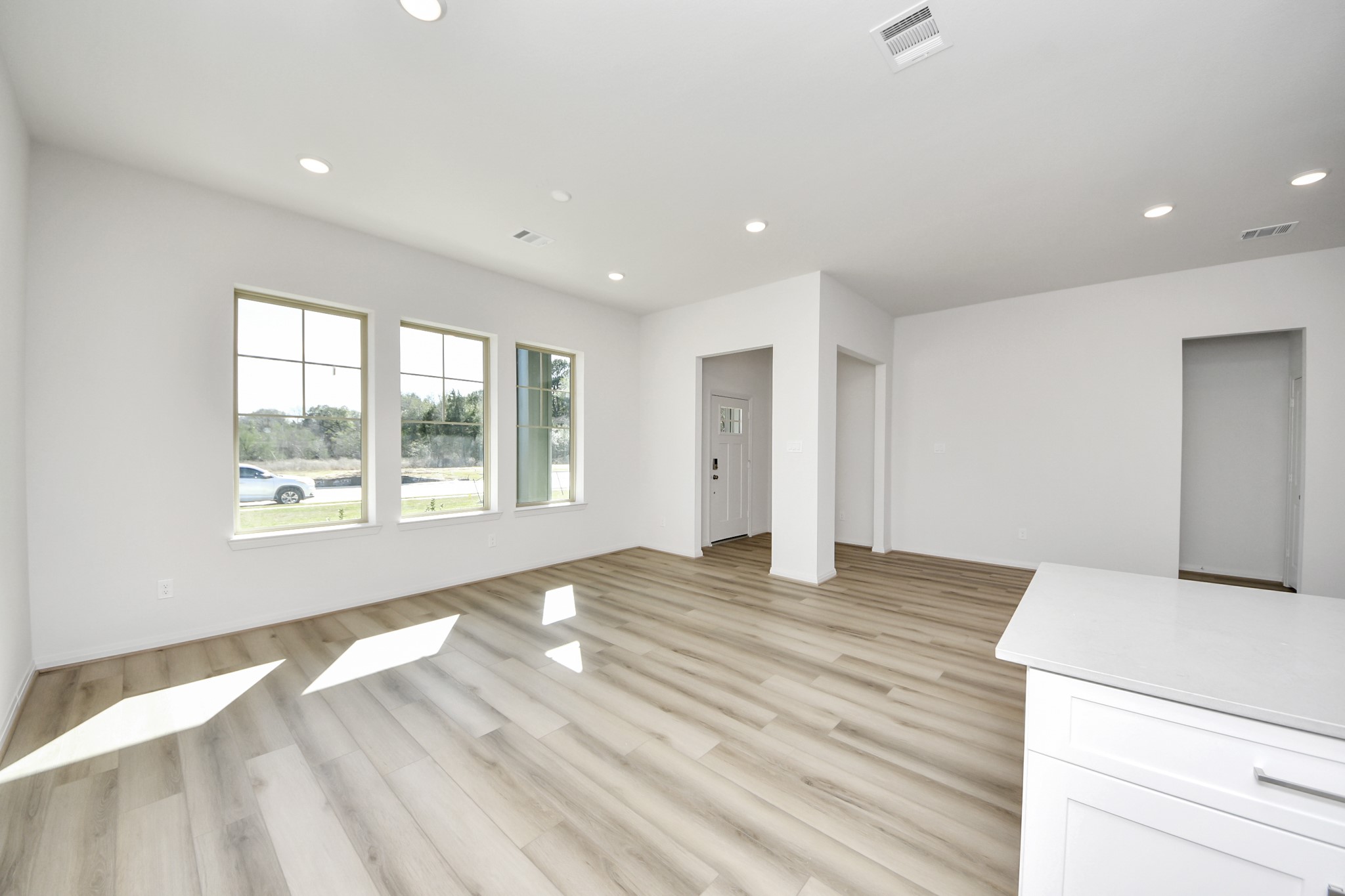 363 Legacy Point, Unit A Sealy, TX 77474 - Photo 4 of 26 a view of an empty room with wooden floor and a window