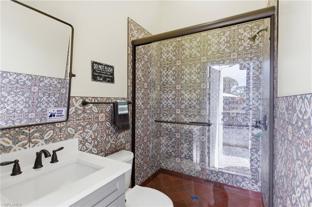 21571 North River Road Alva, FL 33920 - Photo 33 of 48 a bathroom with a sink and a mirror