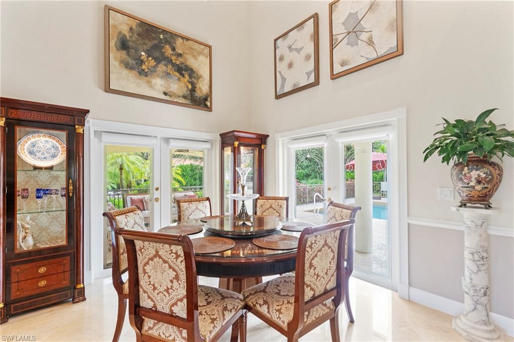 21571 North River Road Alva, FL 33920 - Photo 9 of 48 a dining room with furniture large windows and a potted plant