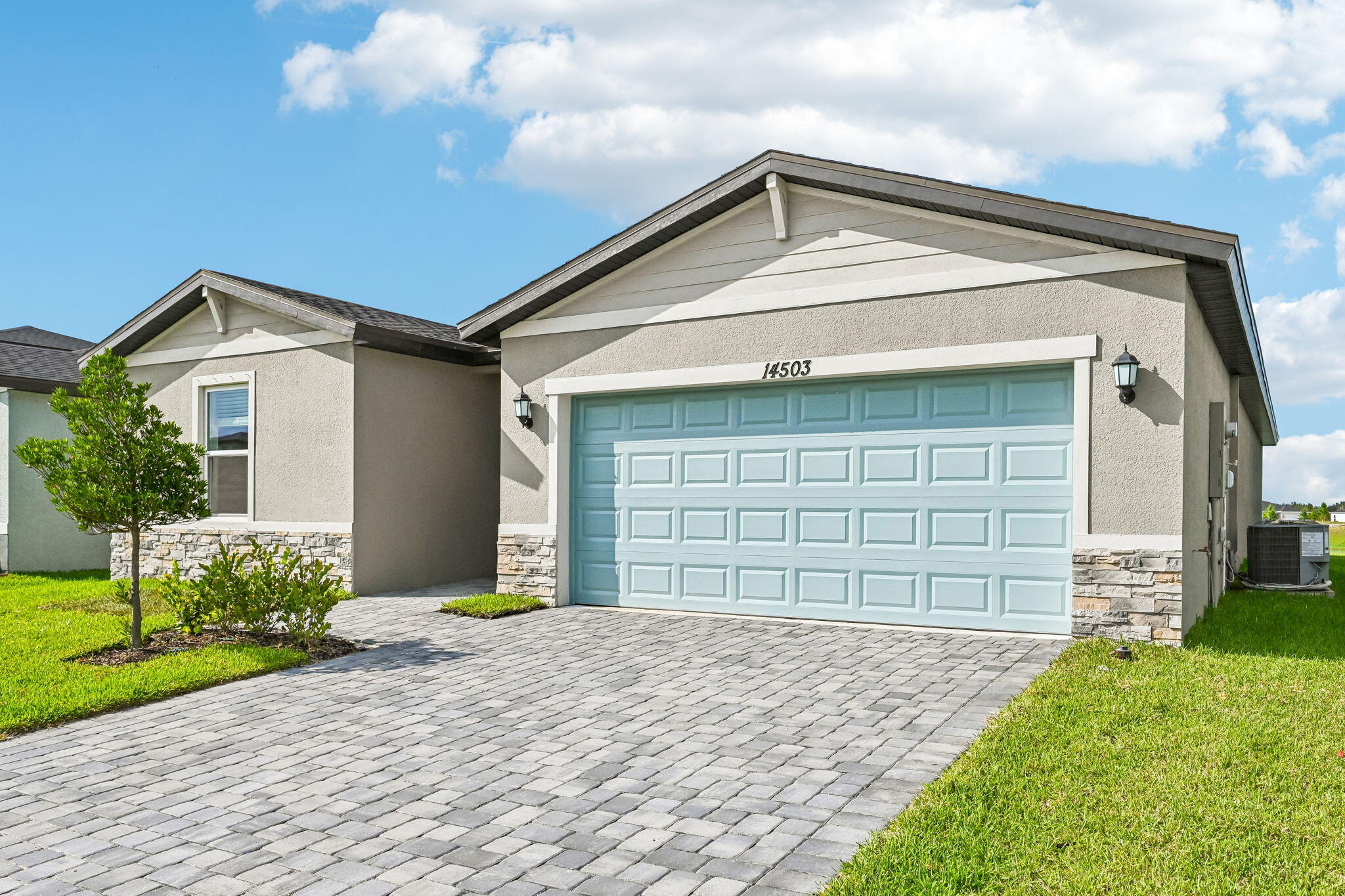 14503 Southwest New Dawn Road Indiantown, FL 34956 - Photo 3 of 42 a front view of a house with a yard