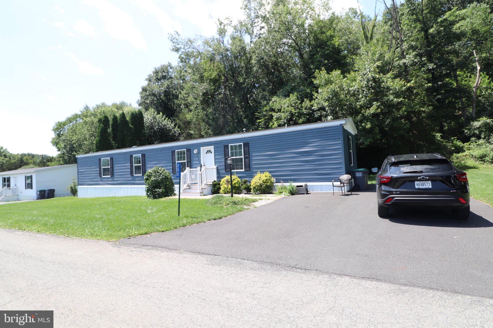 200 Fawn Valley Road Stroudsburg, PA 18360 - Photo 22 of 33 Charming blue home with lush greenery.