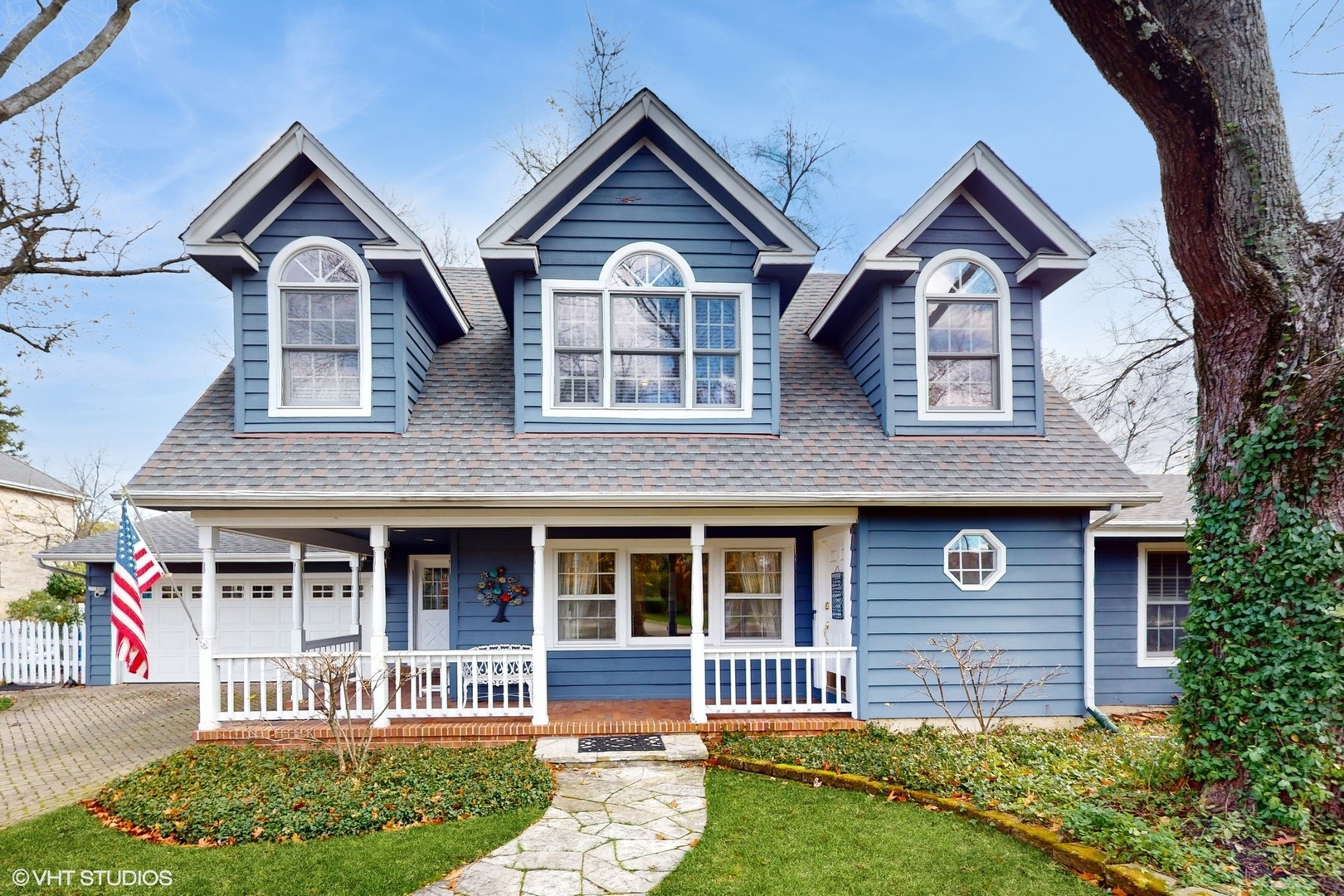 a front view of a house with a garden and plants