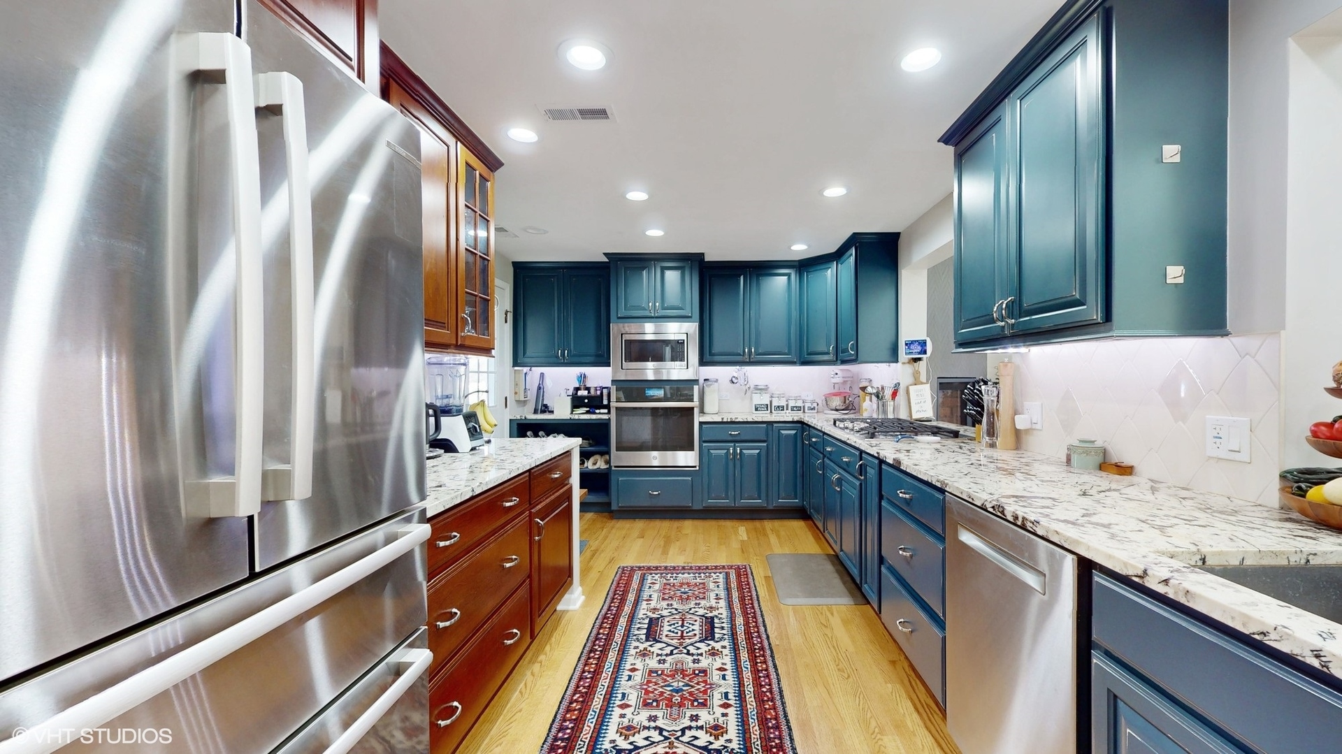 1925 Maple Place Riverwoods, IL 60015 - Photo 10 of 59 a large kitchen with stainless steel appliances granite countertop a refrigerator a sink dishwasher a stove and white cabinets with wooden floor
