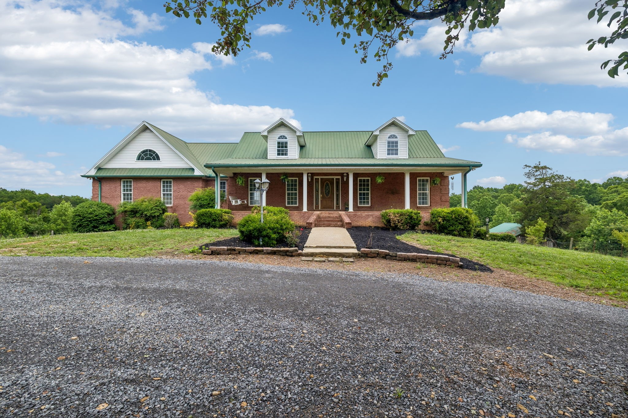 6701 McCormick Ridge Road Whitleyville, TN 38588 - Photo 1 of 63 a front view of a house with a yard and potted plants