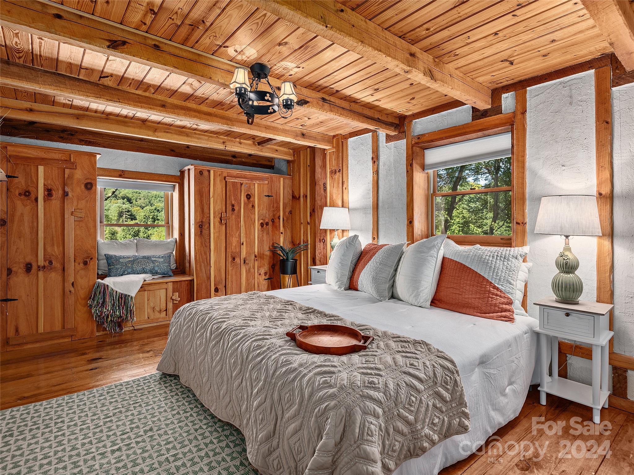 2560 King Road Pisgah Forest, NC 28768 - Photo 12 of 44 a bedroom with a large bed and a chandelier