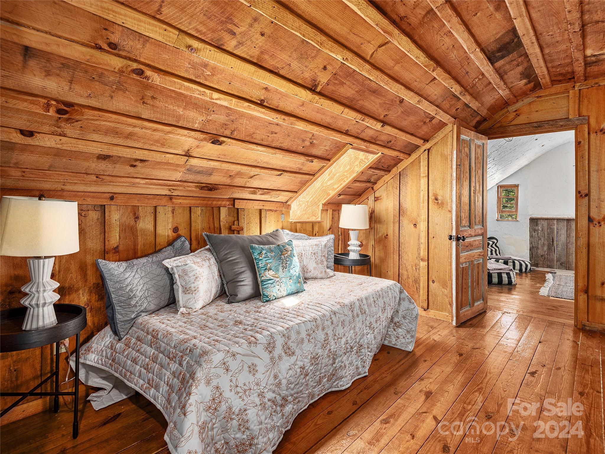 2560 King Road Pisgah Forest, NC 28768 - Photo 14 of 44 a bedroom with a bed and a table