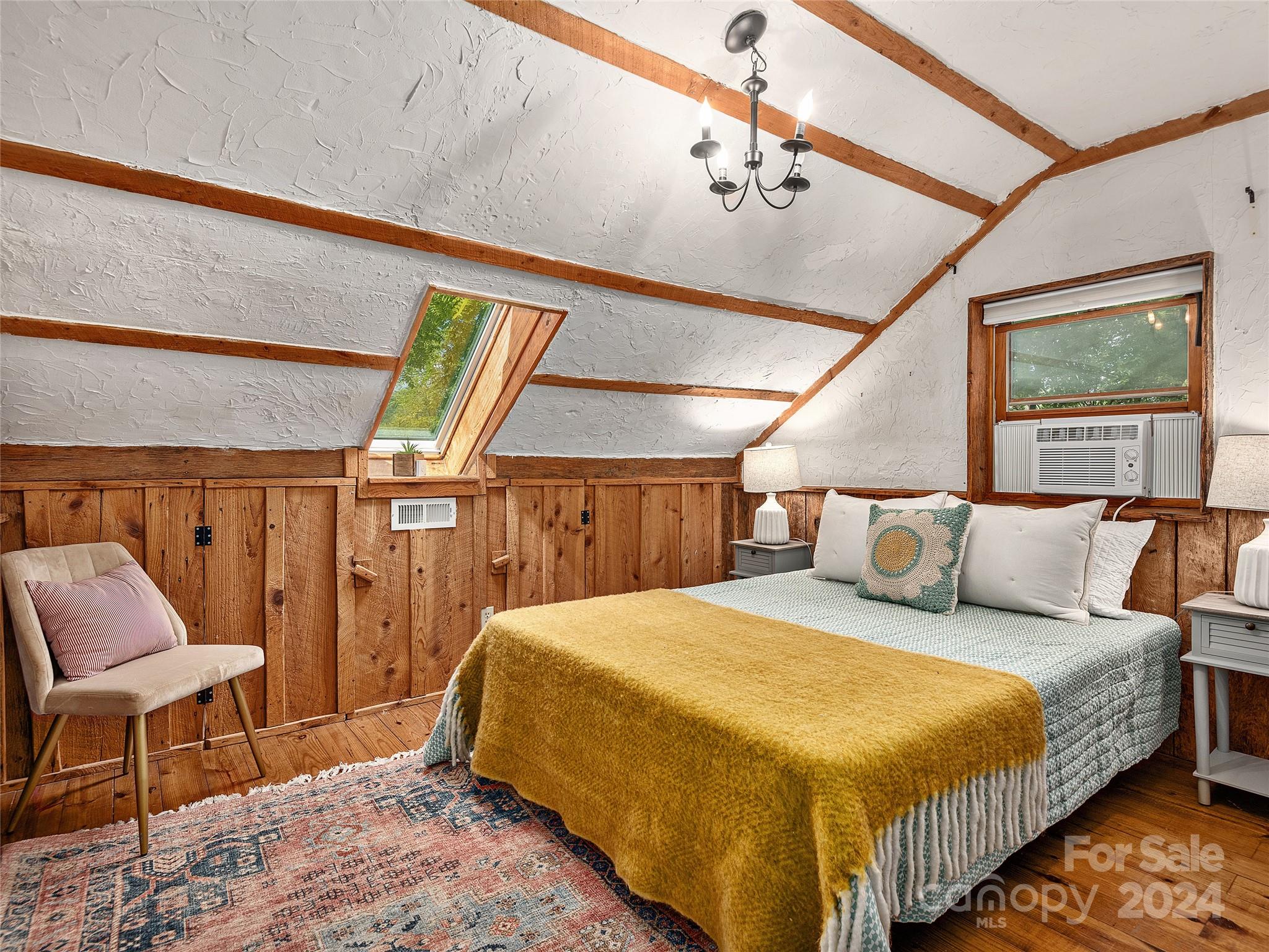 2560 King Road Pisgah Forest, NC 28768 - Photo 16 of 44 a bedroom with a bed a chair and potted plant on the dresser