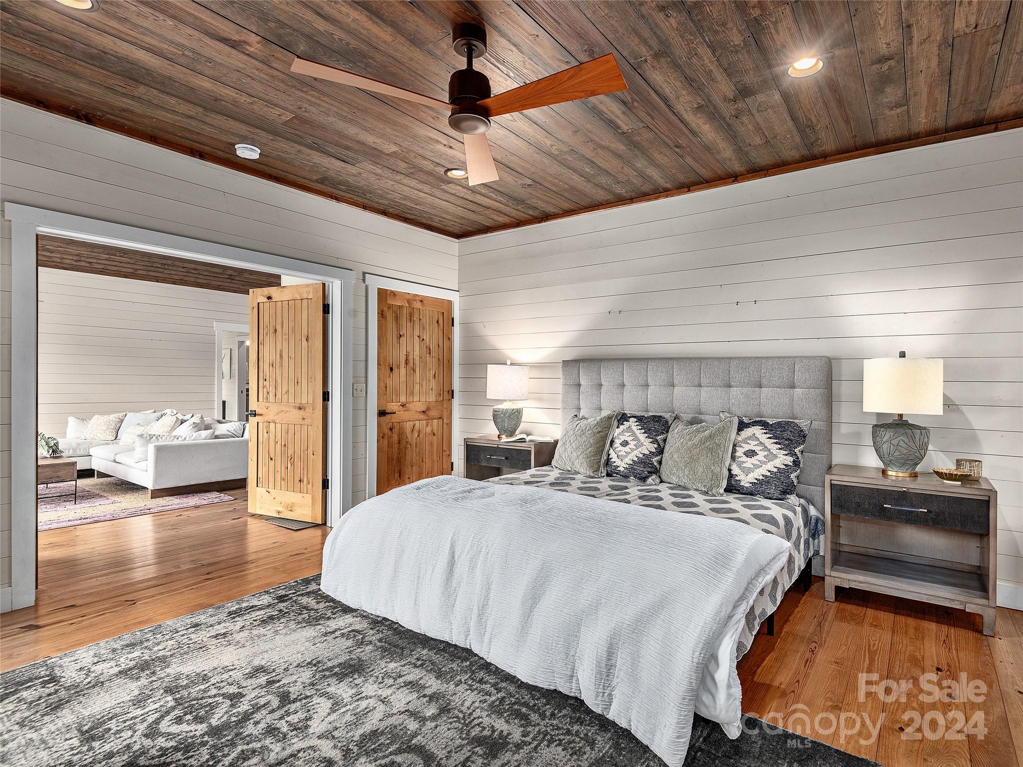 2560 King Road Pisgah Forest, NC 28768 - Photo 27 of 44 a large bedroom with a large bed and wooden floor