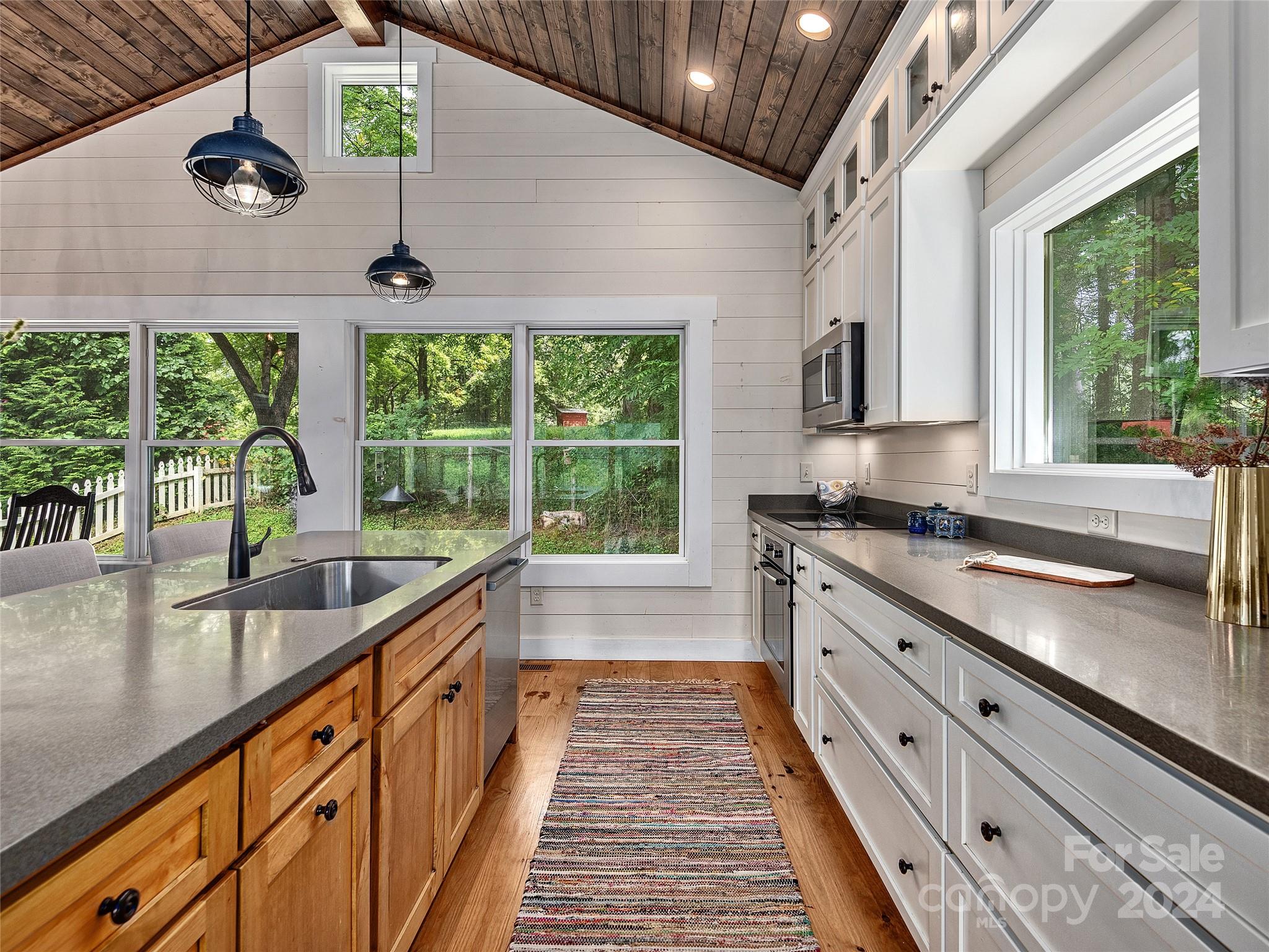 2560 King Road Pisgah Forest, NC 28768 - Photo 32 of 44 a large kitchen with kitchen island a large window cabinets and stainless steel appliances