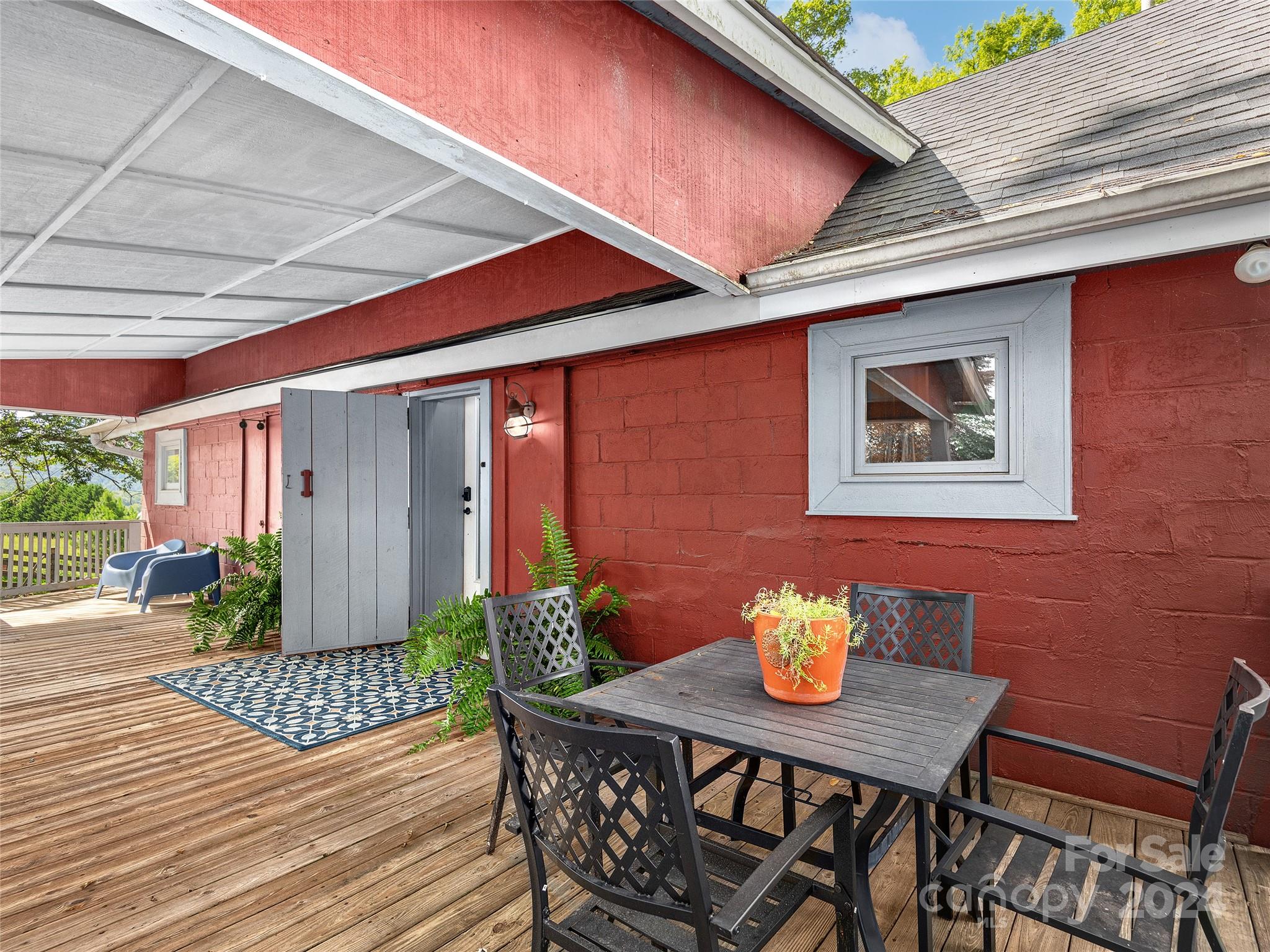 2560 King Road Pisgah Forest, NC 28768 - Photo 4 of 44 a table and chairs in front of a house